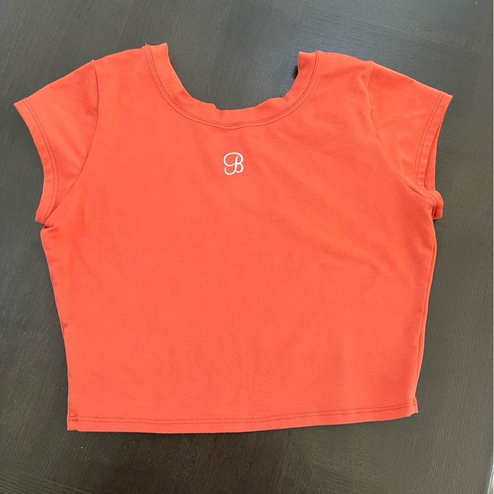Bombshell Sportswear crop top in rusty orange size medium.